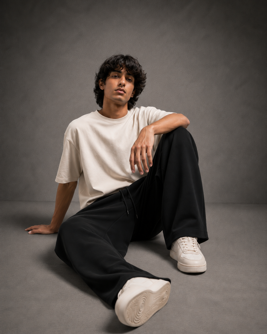UpClothing Seoul Pleat Wide-Leg Joggers in Onyx seated editorial view