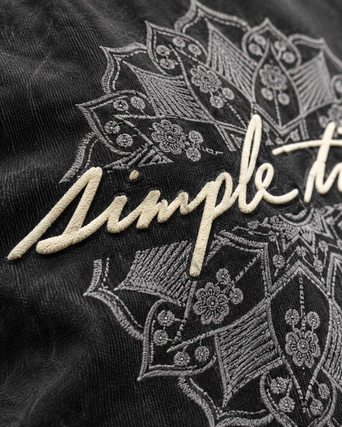 Simple Things Sunfade Puff Tee Washed Black close-up showing raised puff script and embroidery-look DTF detail