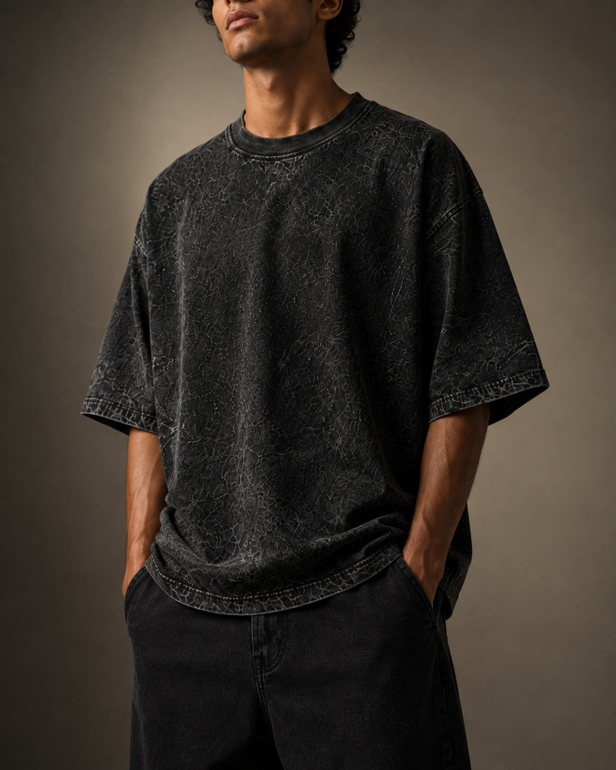 UpClothing Core Wash 240 Onyx Black acid wash oversized T-shirt — torso crop showing wash texture and drape