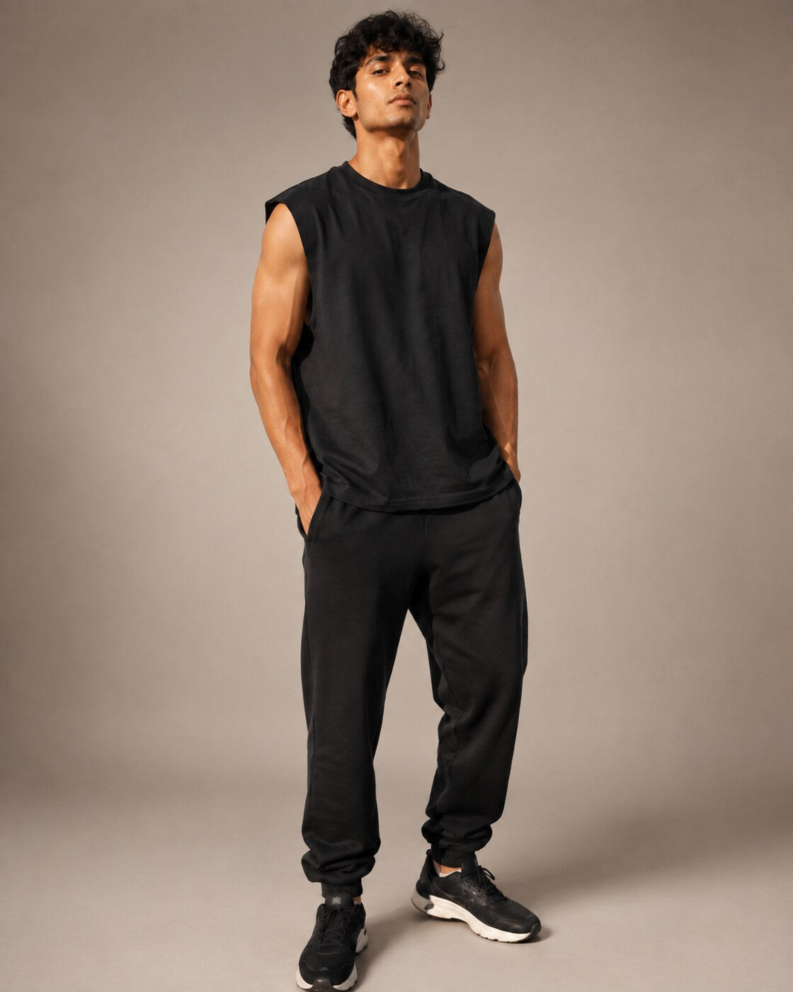 Indian male model wearing UpClothing Off-Duty Oversized Vest in Onyx Black front view