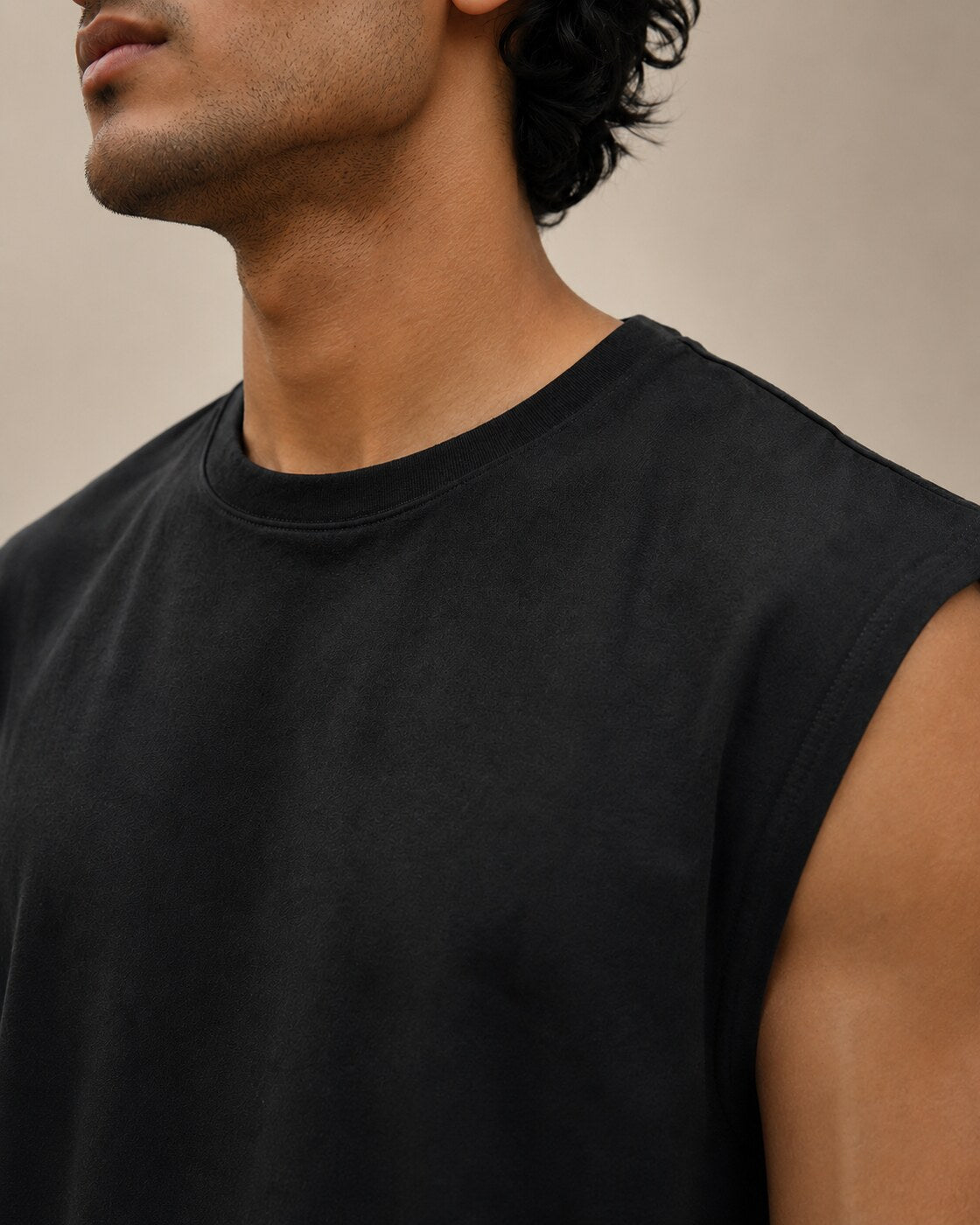 Close-up of neckline, shoulder seam and cotton texture on UpClothing Onyx Black oversized vest